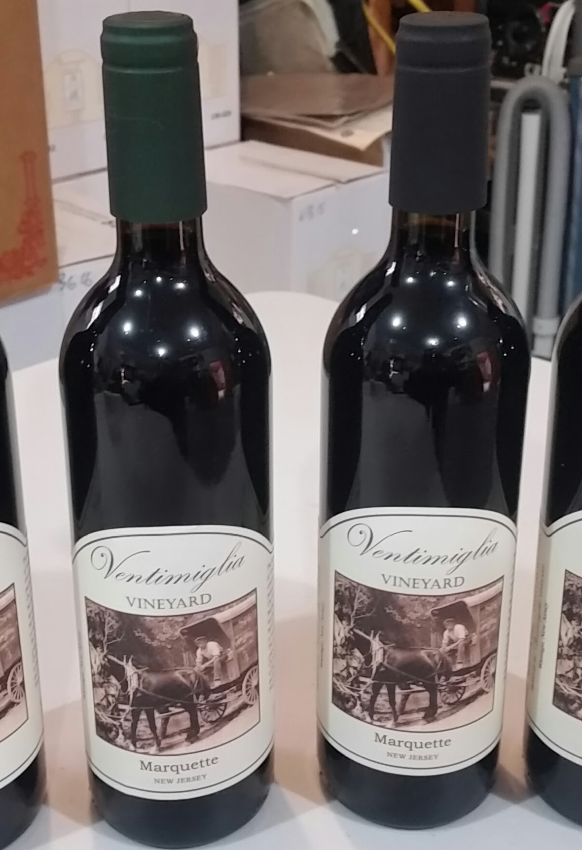 Two bottles of red wine with vintage-style labels displayed.